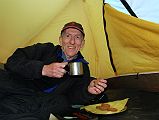 02 Jerome Ryan Enjoying Afternoon Tea And Cookies At Kharka On Way To Mesokanto La The trail climbs up the valley from Thini, keeping to the left and away from the Nepalese army in the restricted military area. We stayed the night at a kharka at 3460m. Jerome Ryan enjoyed afternoon tea and cookies in his tent.
